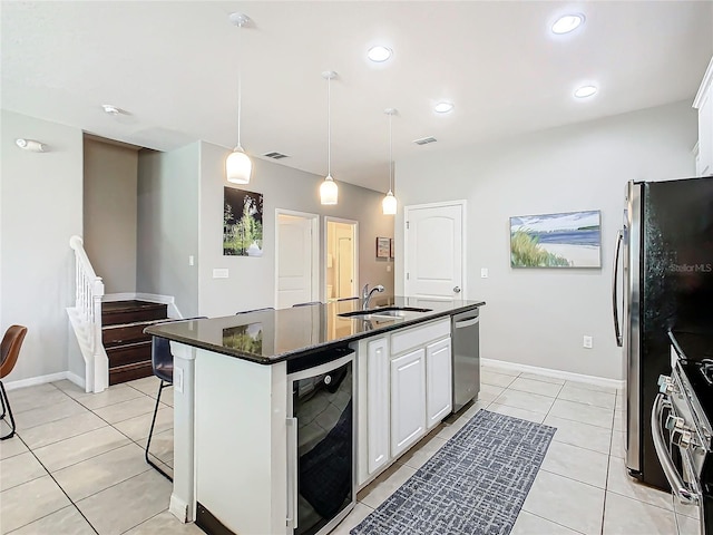 kitchen with a kitchen island with sink, white cabinets, sink, stainless steel appliances, and beverage cooler