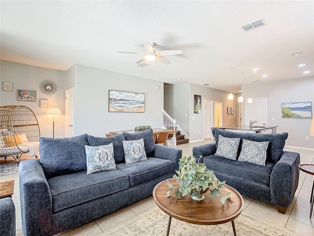 living room with ceiling fan and light tile patterned floors