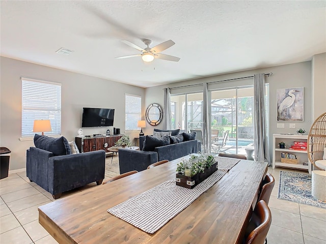 tiled dining space with ceiling fan