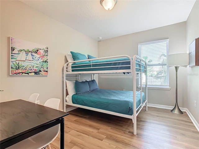 bedroom with hardwood / wood-style floors