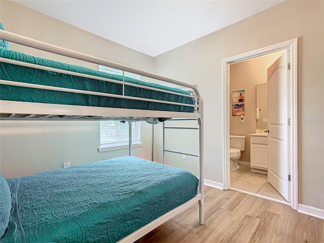 bedroom with sink and light hardwood / wood-style floors