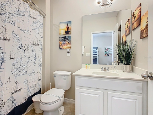 bathroom featuring tile patterned floors, vanity, and toilet