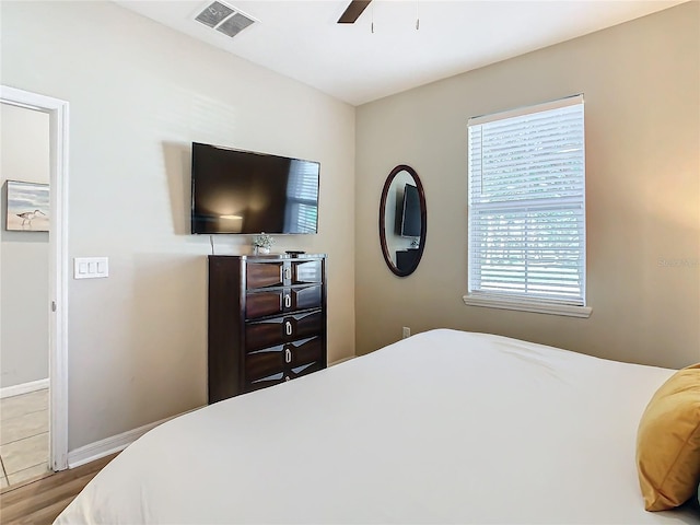 bedroom with ceiling fan and wood-type flooring