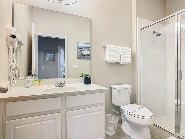 bathroom featuring toilet, vanity, tile patterned floors, and walk in shower