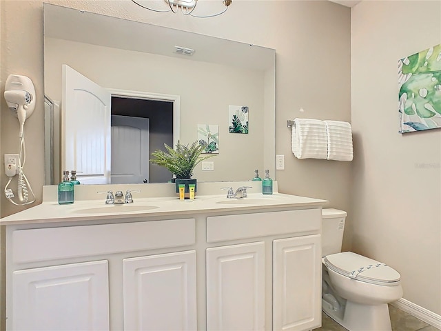 bathroom with tile patterned floors, vanity, and toilet