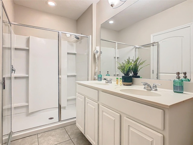 bathroom with tile patterned floors, vanity, and a shower with shower door