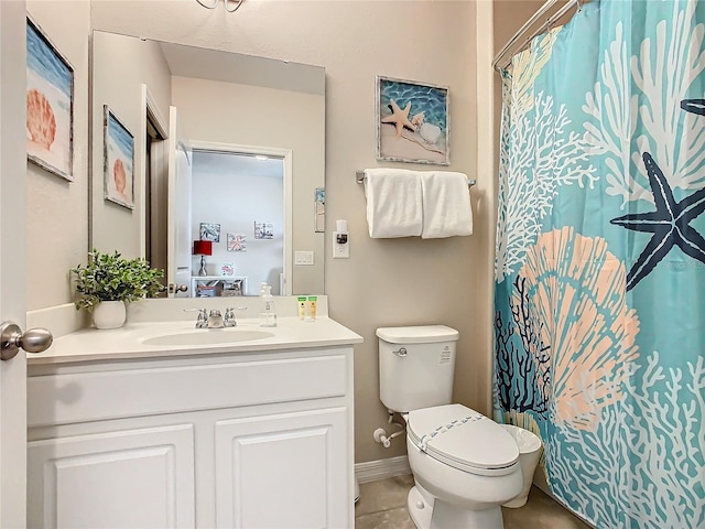 bathroom with tile patterned flooring, vanity, and toilet