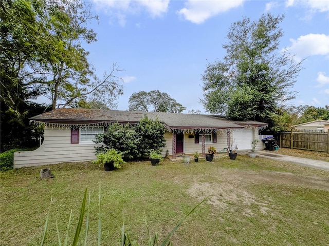 view of front of property featuring a front yard and a garage