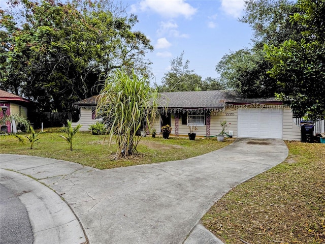 ranch-style house featuring a garage and a front lawn