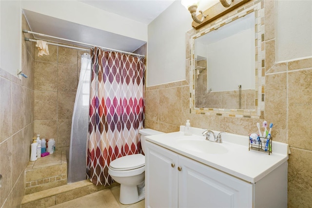 bathroom with a shower with shower curtain, vanity, toilet, and tile walls