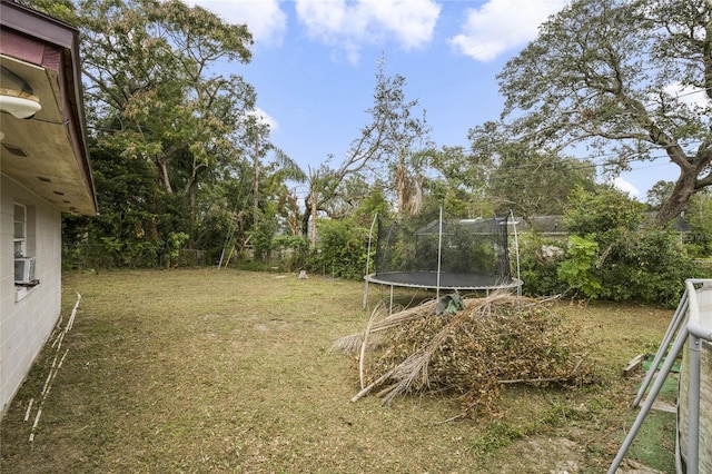 view of yard featuring cooling unit and a trampoline