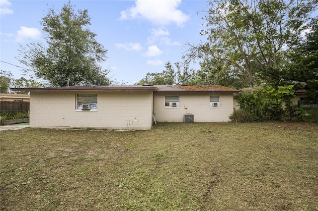 rear view of house featuring a lawn