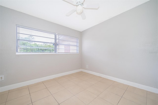 tiled empty room featuring ceiling fan and vaulted ceiling