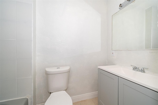 bathroom featuring tile patterned flooring, vanity, and toilet