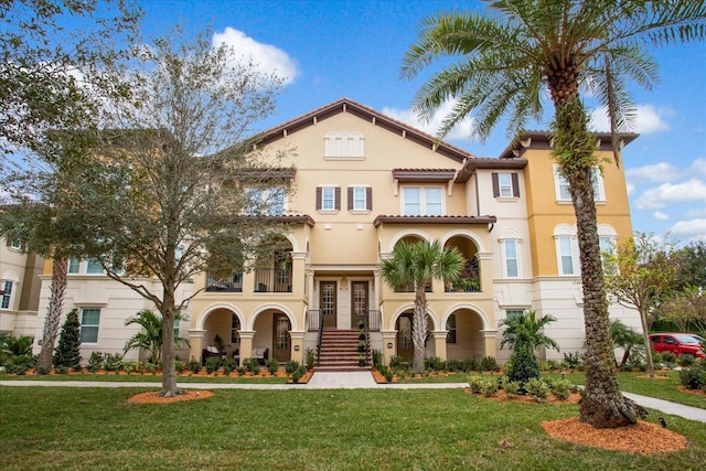 mediterranean / spanish-style home with a front lawn