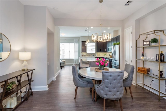 dining room featuring dark hardwood / wood-style floors and a notable chandelier