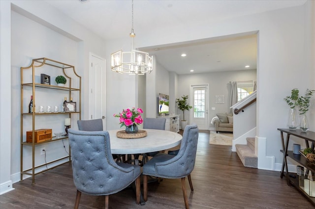 dining space featuring a chandelier and dark hardwood / wood-style floors