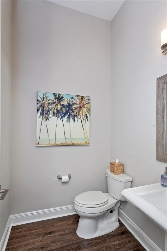 bathroom with hardwood / wood-style floors and toilet