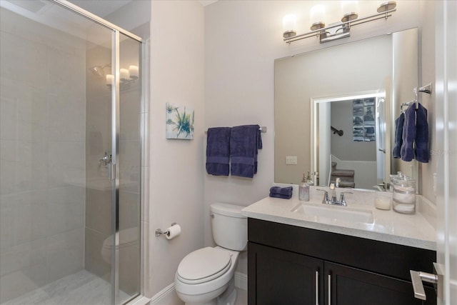 bathroom featuring vanity, toilet, and a shower with door