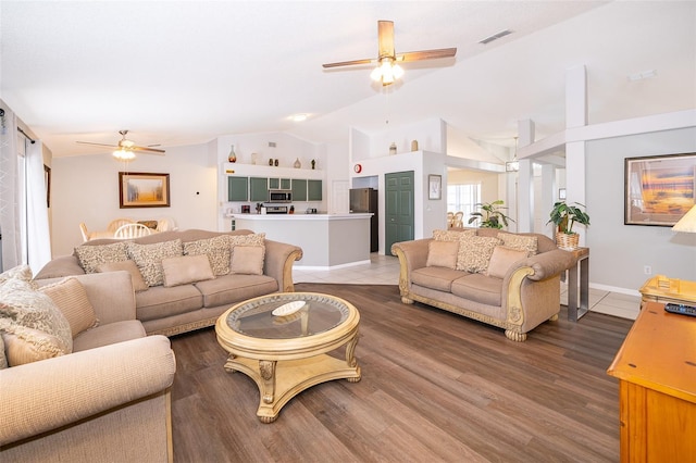 living room featuring wood-type flooring, vaulted ceiling, and ceiling fan