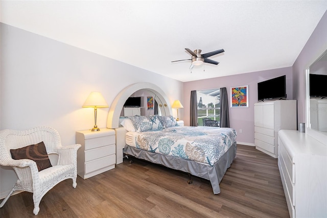 bedroom with dark hardwood / wood-style floors and ceiling fan