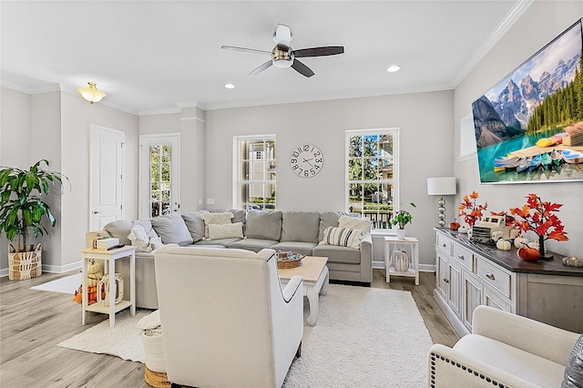 living room featuring ceiling fan, light hardwood / wood-style floors, and ornamental molding