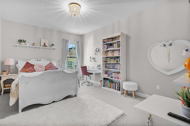 carpeted bedroom featuring a textured ceiling