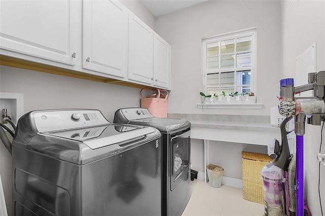 laundry area with cabinets and washing machine and clothes dryer