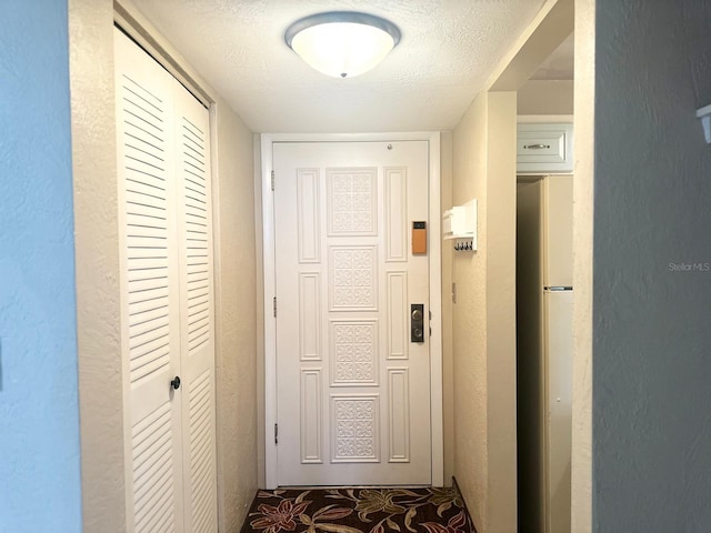 corridor with a textured ceiling