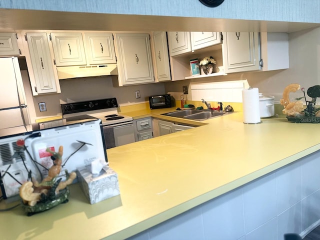 kitchen with white cabinets, white electric range oven, sink, and fridge