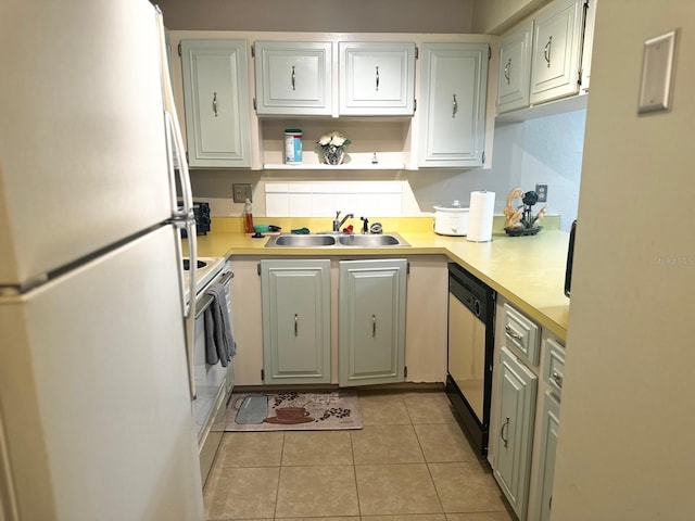 kitchen featuring light tile patterned floors, white appliances, and sink