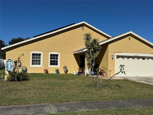 ranch-style house with a garage and a front yard