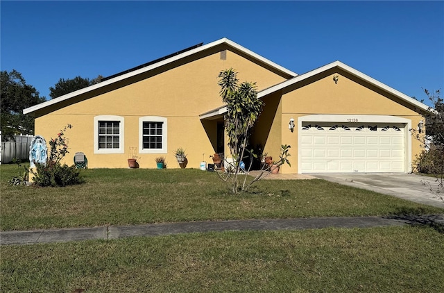 ranch-style home with a garage and a front lawn