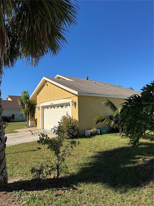 view of front of house featuring a garage and a front lawn