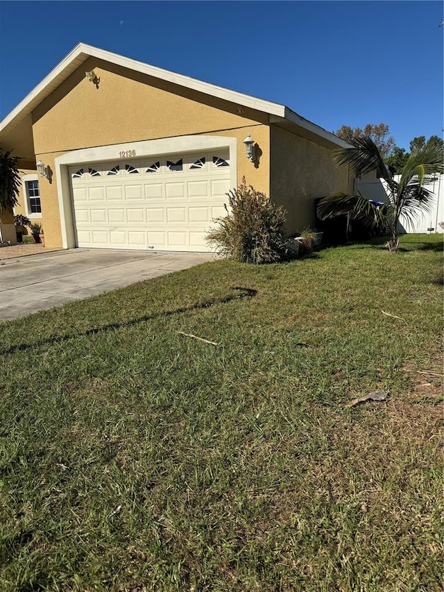 view of side of property featuring a lawn and a garage