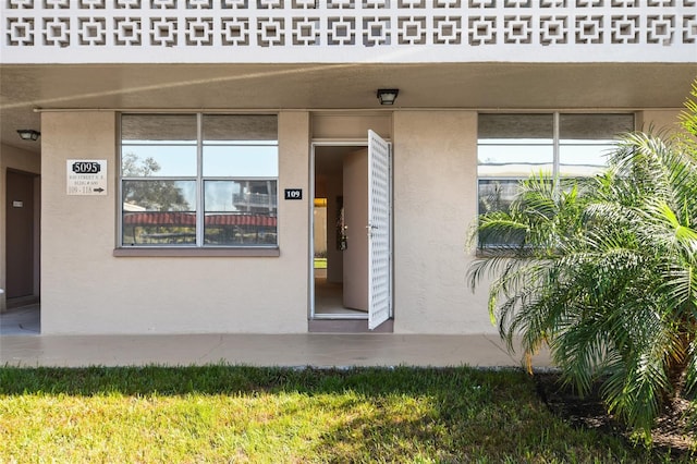 doorway to property with a yard