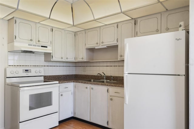 kitchen featuring white cabinetry, sink, and white appliances