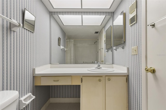 bathroom featuring a shower with curtain, vanity, and toilet