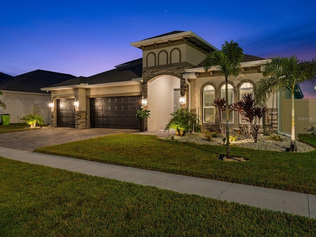 view of front of home featuring a lawn and a garage