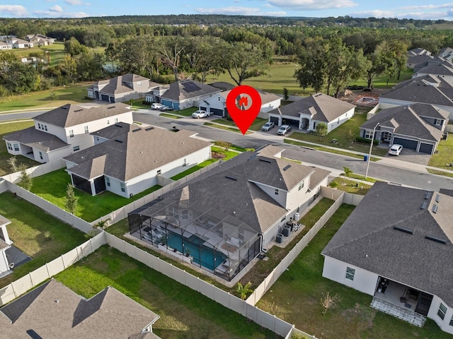 aerial view featuring a wooded view and a residential view