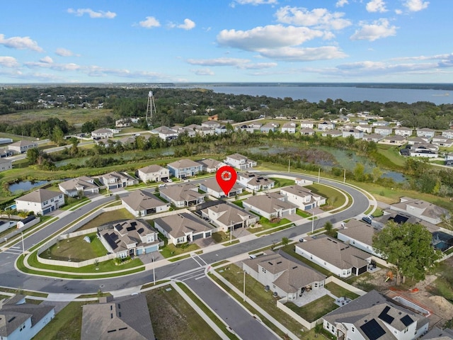 drone / aerial view featuring a residential view and a water view