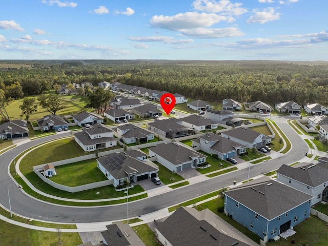 aerial view with a residential view and a wooded view