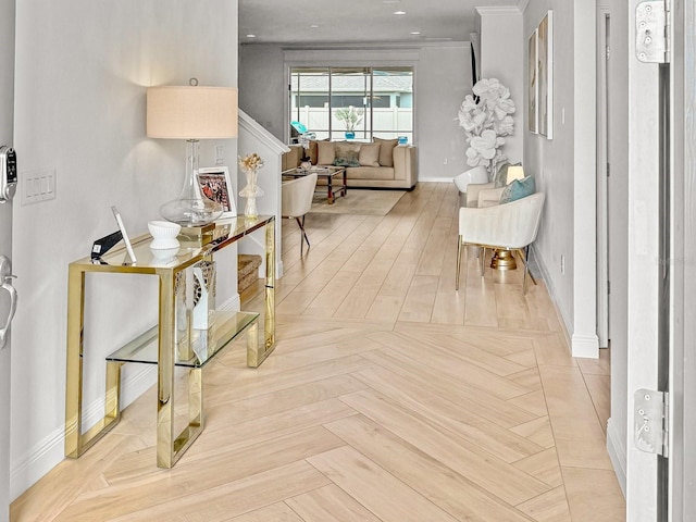 hall featuring crown molding and baseboards