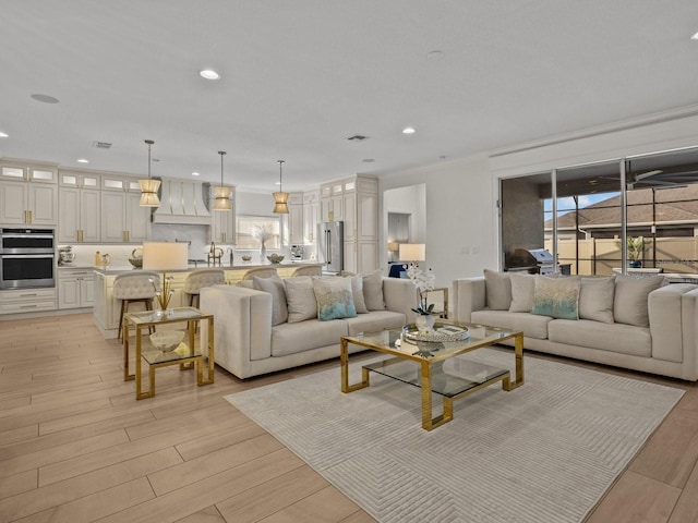 living area featuring recessed lighting, plenty of natural light, and light wood finished floors