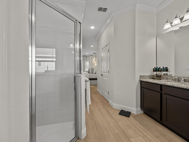 bathroom featuring visible vents, a shower stall, crown molding, and wood finished floors