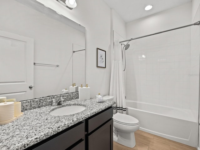 full bath with vanity, toilet, wood finished floors, and shower / tub combo