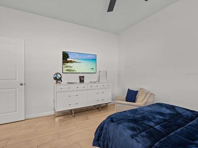 bedroom with light wood-style flooring, baseboards, and ceiling fan