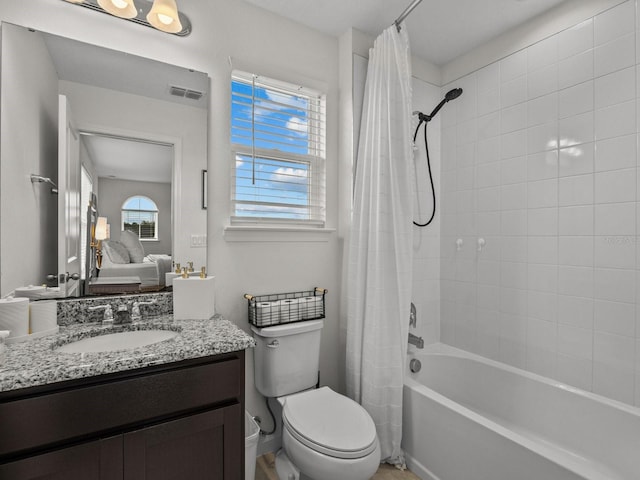 full bathroom featuring visible vents, toilet, shower / bath combination with curtain, baseboards, and vanity