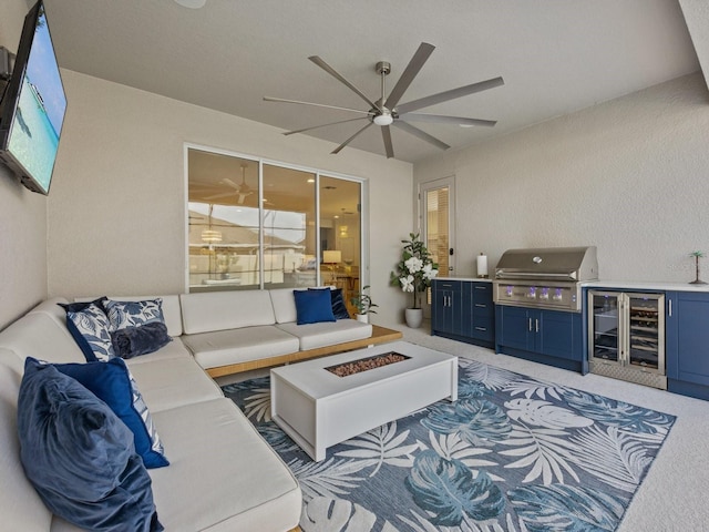 living room featuring ceiling fan, a textured wall, and light carpet