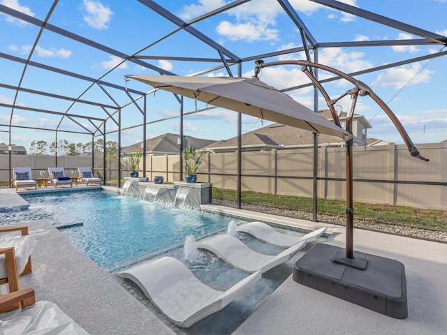 view of swimming pool with glass enclosure, a patio, a fenced in pool, and a fenced backyard